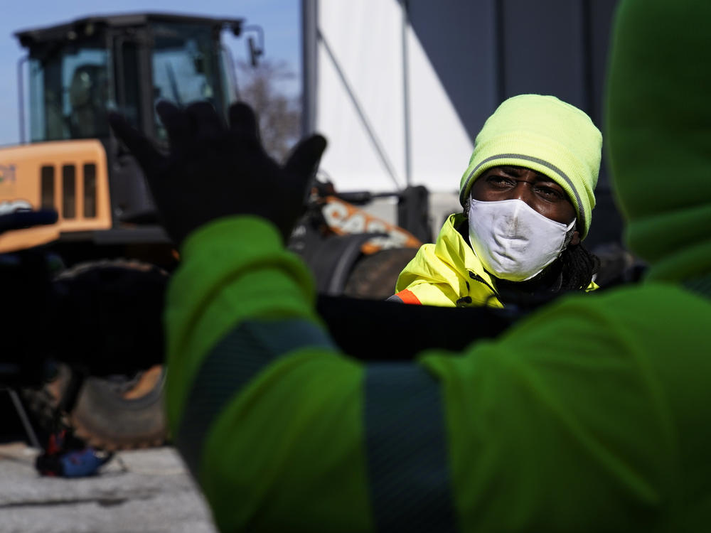 A Georgia Department of Transportation response member looks at a brine truck tank being filled ahead of a winter storm at the GDOT's Maintenance Activities Unit location on Friday, Jan. 14, 2022, in Forest Park, Ga.