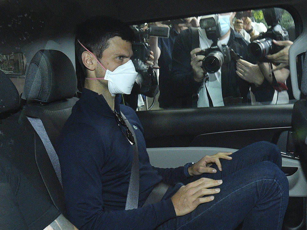 Serbian tennis player Novak Djokovic rides in car as he leaves a government detention facility before attending a court hearing at his lawyers office in Melbourne, Australia, on Jan. 16, 2022.