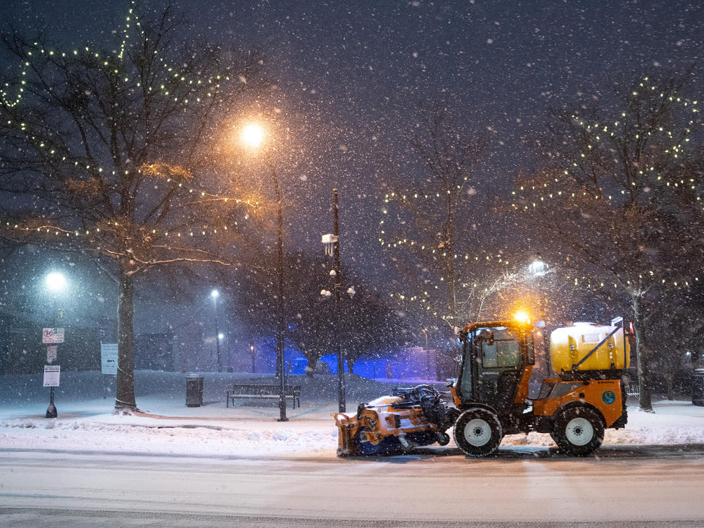 A snow plow clears Main St. on January 16, 2022 in Greenville, South Carolina. Snow, sleet and freezing rain are expected in the area for the remainder of the day.