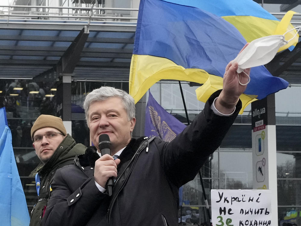 Former Ukrainian President Petro Poroshenko gestures while speaking to his supporters upon his arrival at Zhuliany International Airport outside Kyiv, Ukraine, Monday, Jan. 17, 2022.