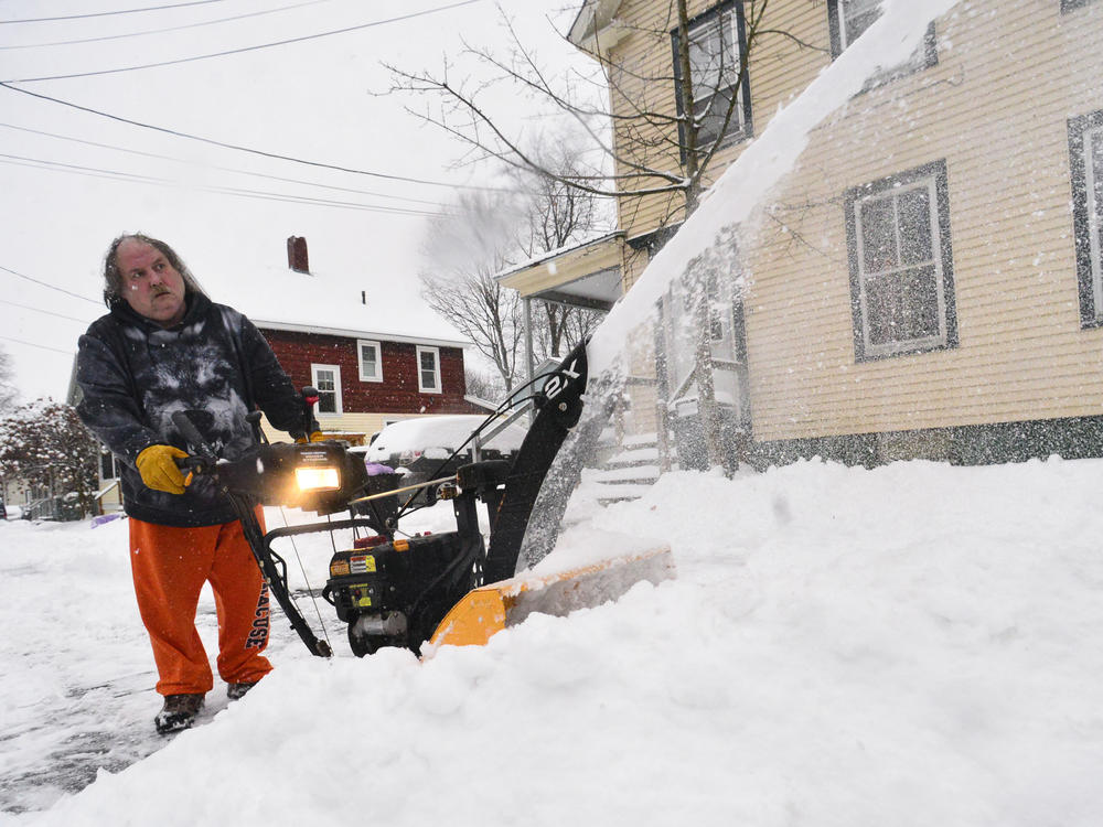 Harry Ruester, of Brattleboro, Vt., uses a snowblower while removing snow from his driveway during a snowstorm on Monday, Jan. 17, 2022.