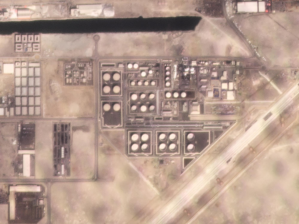 In this satellite image provided by Planet Labs PBC, white fire suppressing foam is seen after an attack on an Abu Dhabi National Oil Co. fuel depot in the Mussafah neighborhood of Abu Dhabi, United Arab Emirates, Monday, Jan. 17, 2022.