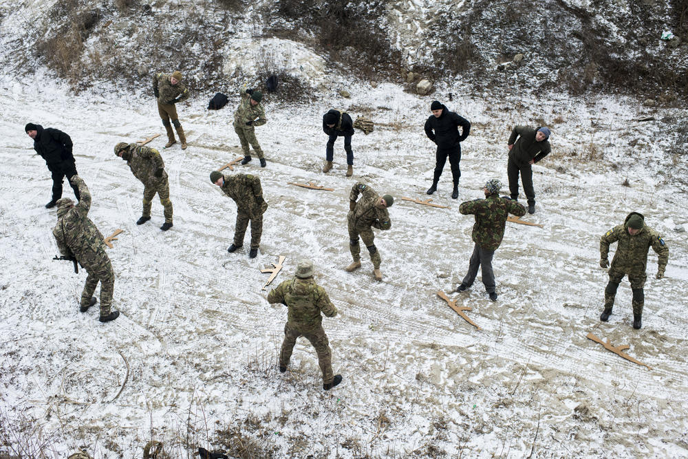 Members of the Territorial Defense Forces stretch before taking part in training in January. As Ukrainians prepare for a possible Russian invasion, thousands of citizens are volunteering to train in case they have to help protect their cities.