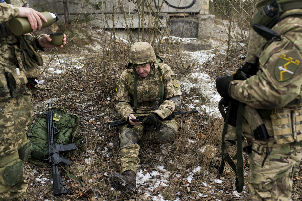 Members of the Territorial Defense Forces take a break during training. Many of the volunteers are old enough to remember when Russians and Ukrainians were Soviet brothers.