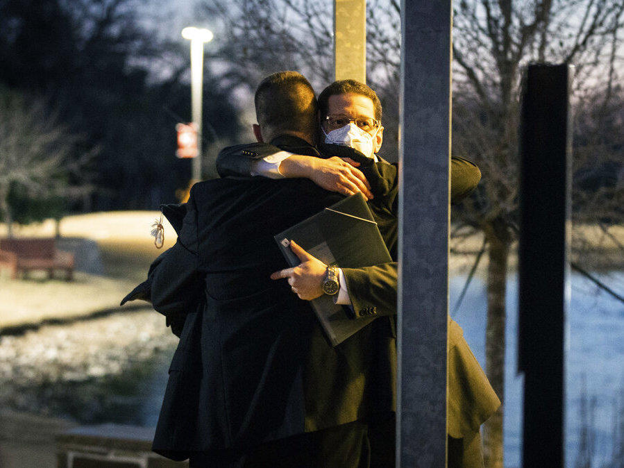Congregation Beth Israel Rabbi Charlie Cytron-Walker, facing camera, hugs a man after a healing service Monday night, Jan. 17, 2022, at White's Chapel United Methodist Church in Southlake, Texas.