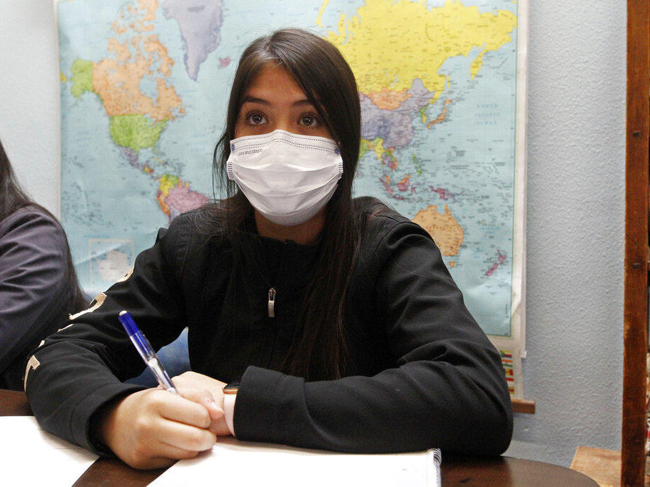 Jazmin Cazares, 14, takes notes as teacher Wendy Leighton discusses the Salem witch trials with her students at Monte del Sol Charter School, Friday, Dec. 3, 2021, in Santa Fe, N.M.