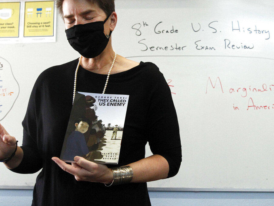 History teacher Wendy Leighton holds a copy of 