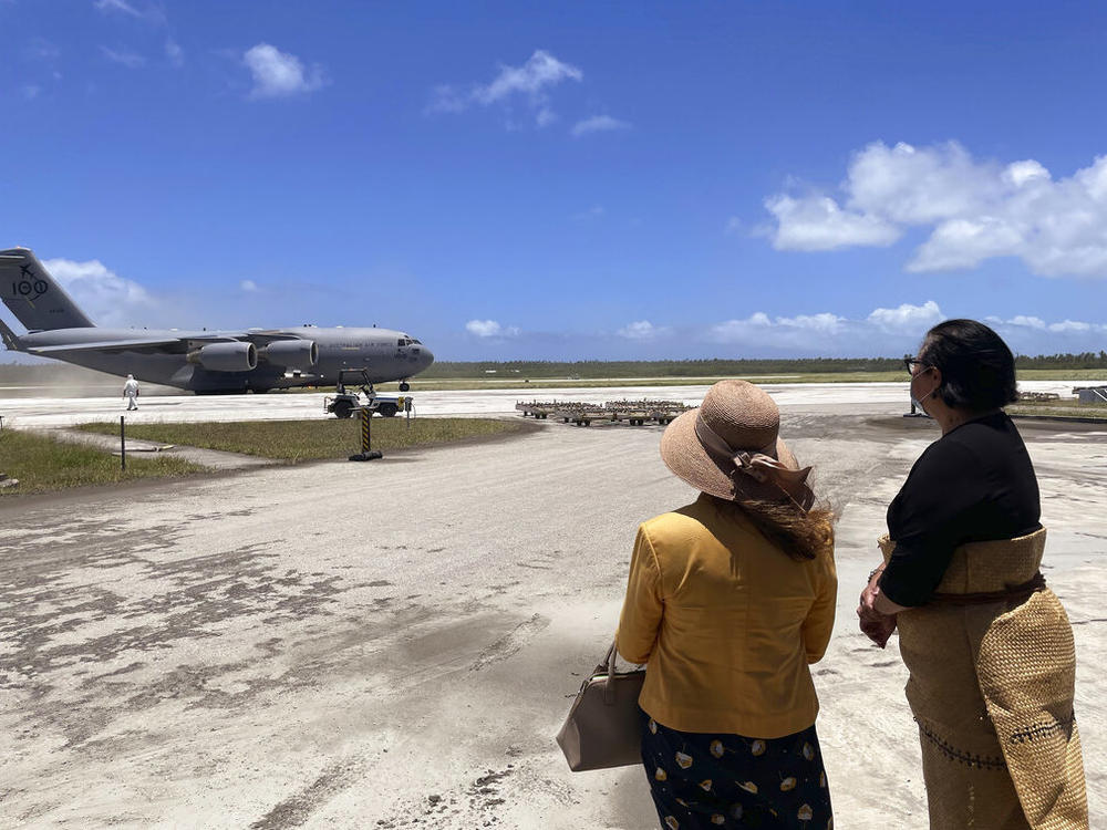 Tongan Foreign Minister Fekitamoeloa 'Utoikamanu (right) is accompanied by Australian High Commissioner to Tonga Rachael Moore as they receive a Royal Australian Air Force C-17A Globemaster III aircraft delivering Australian aid at Fuaʻamotu International Airport on Thursday.