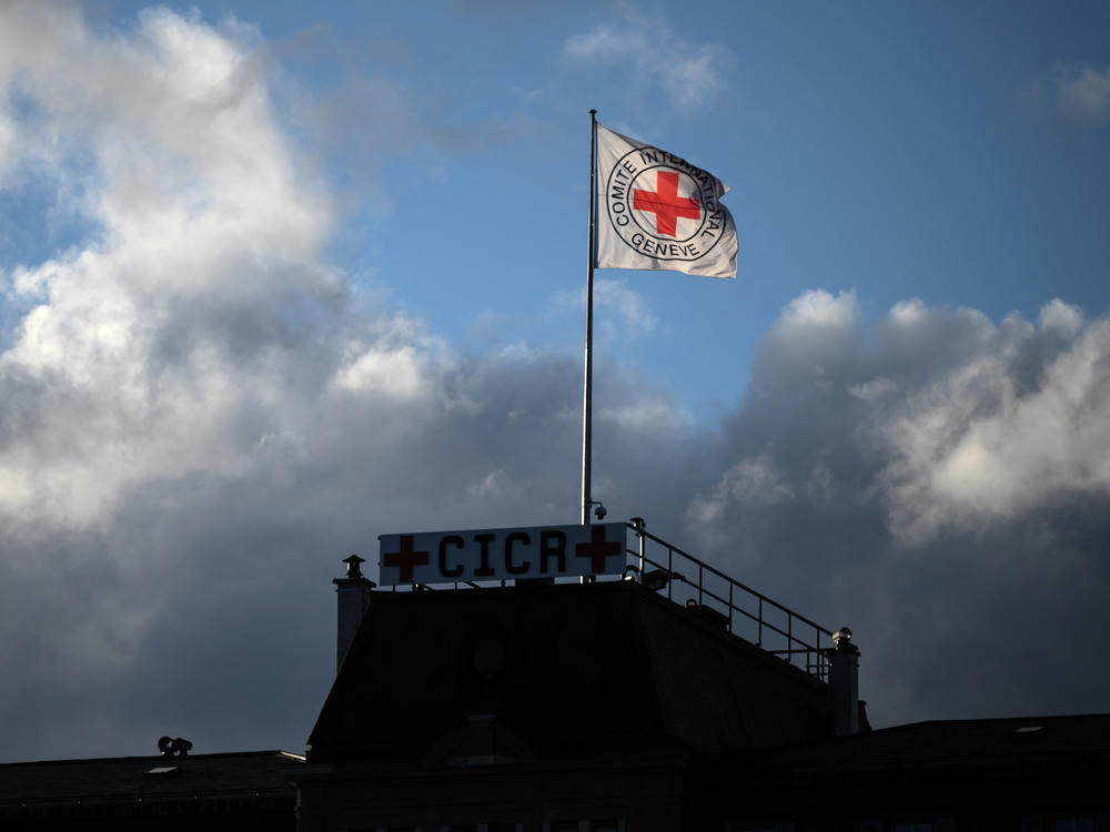 A flag of the International Committee of the Red Cross flutters above the humanitarian organization's headquarters in Geneva on Sept. 29, 2021. The ICRC is pleading with hackers to keep stolen data confidential.