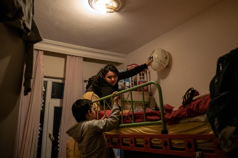 Aysu, 10, and Lütfullah play with a balloon in their bedroom in Istanbul. Aysu was only 6 years old and Lütfullah was only 4 when they were sent to separate boarding schools in Xinjiang. When they returned, they were malnourished and could no longer speak Uyghur or Turkish.