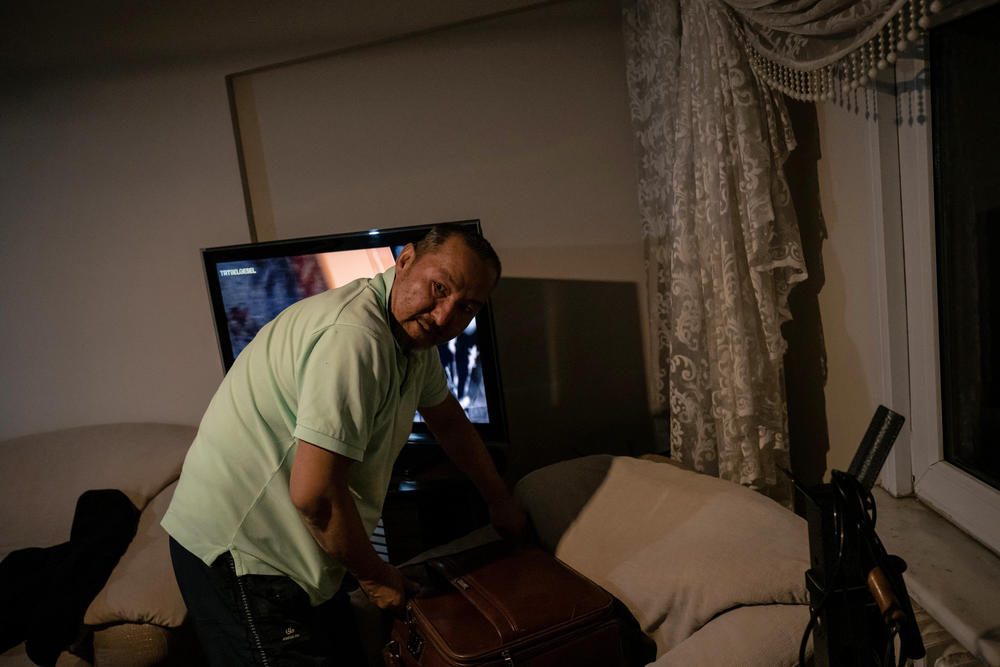 Abdüllatif Kuçar, 54, looks through an old suitcase for photos and documents at his home in Istanbul. After moving to Turkey in 1986, he regularly shuttled between Istanbul and Xinjiang's capital of Urumqi.