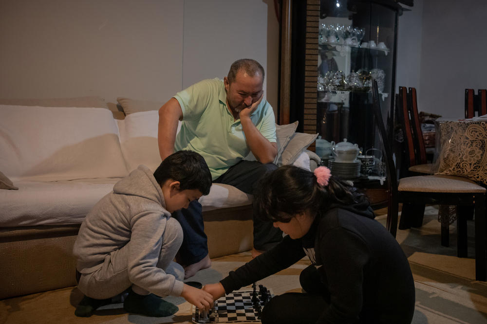 Abdüllatif Kuçar watches his two children play chess in the living room. Lütfullah and Aysu are slowly acclimating to life in Istanbul, but when they were first reunited with their father, they suffered from intense nightmares.