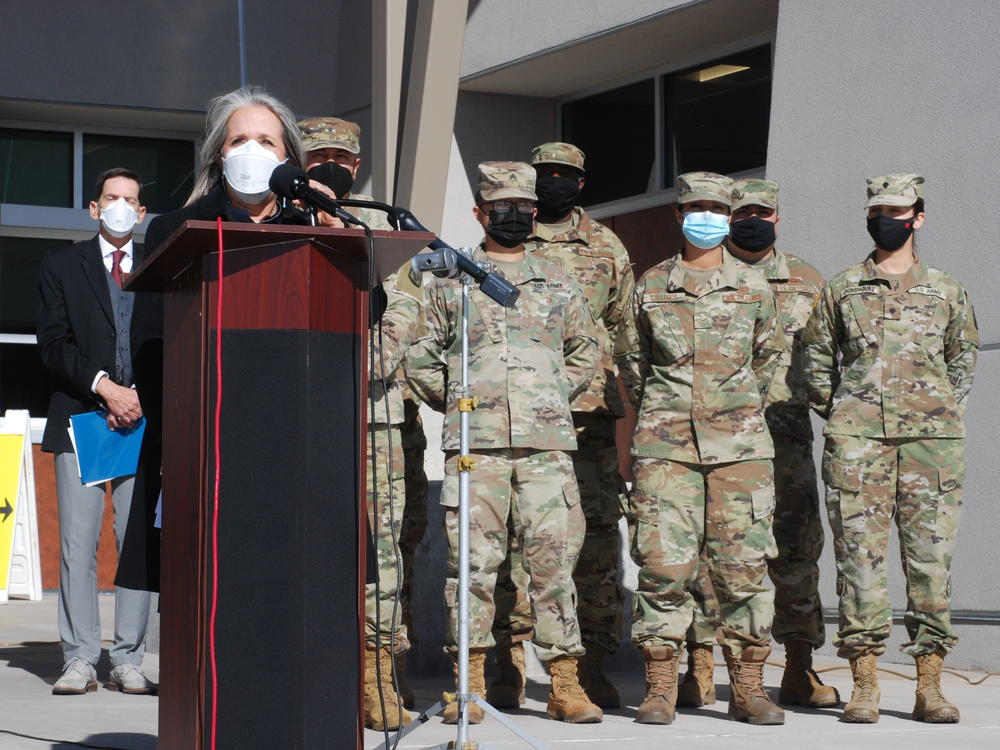 New Mexico Gov. Michelle Lujan Grisham announced efforts to temporarily employ National Guard troops and state workers as substitute teachers and child care center workers during a news conference at Sante Fe High School in Santa Fe, N.M., on Tuesday.