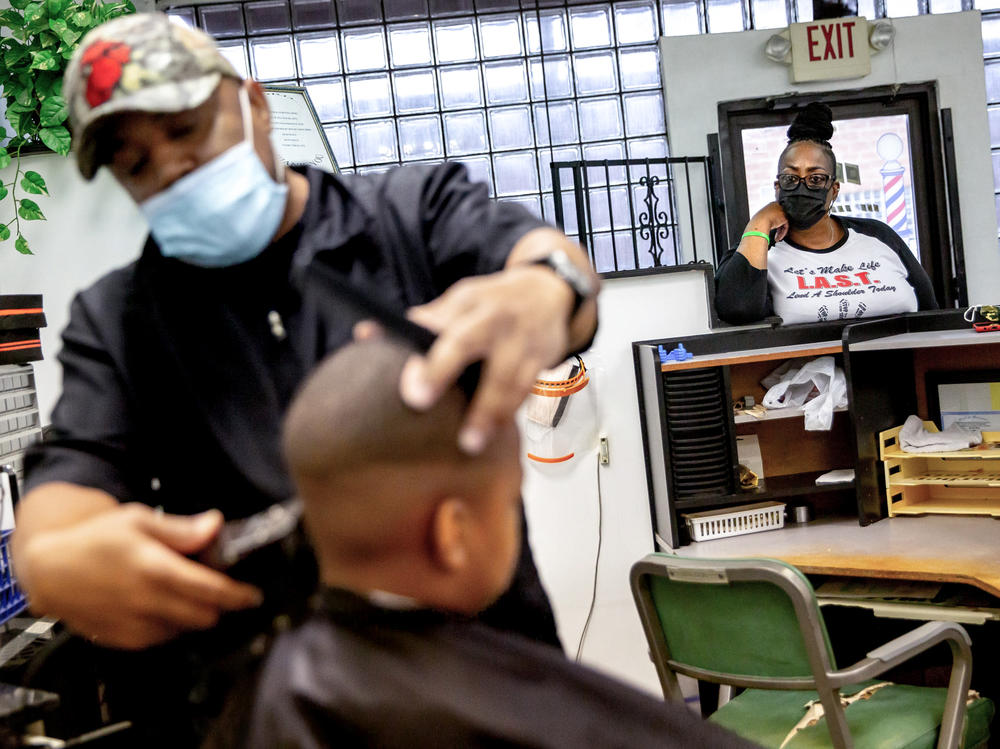 Reba Rice-Portwood talks to her grandson Jackson Portwood, 6, receives a haircut from barber Michael Blissitt, of St. Louis, on Thursday, Nov. 11, 2021, at Elle' Inner-city Salon in St. Louis, Missouri. Rice-Portwood is raising Jackson after her son died by suicide.