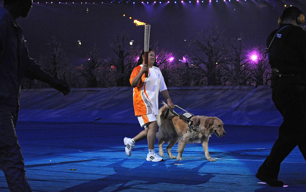 Ping Yali, who was China's first Paralympics gold medalist, carries the flame at the National Stadium during the opening ceremony for the 2008 Beijing Paralympic Games in the Chinese capital on Sept. 6, 2008.