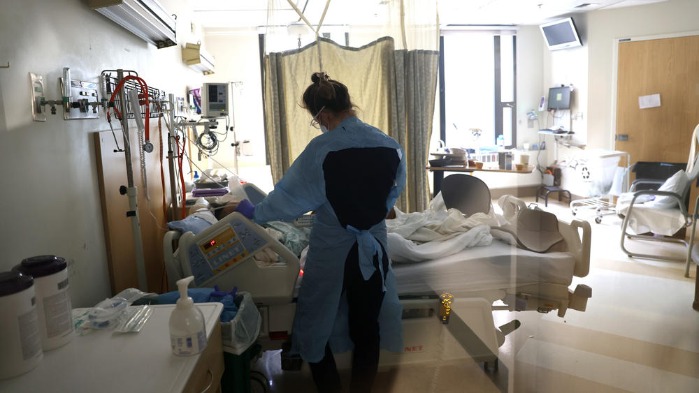 A nurse checks on a patient in the acute care COVID-19 unit at the Harborview Medical Center in Seattle on Friday.
