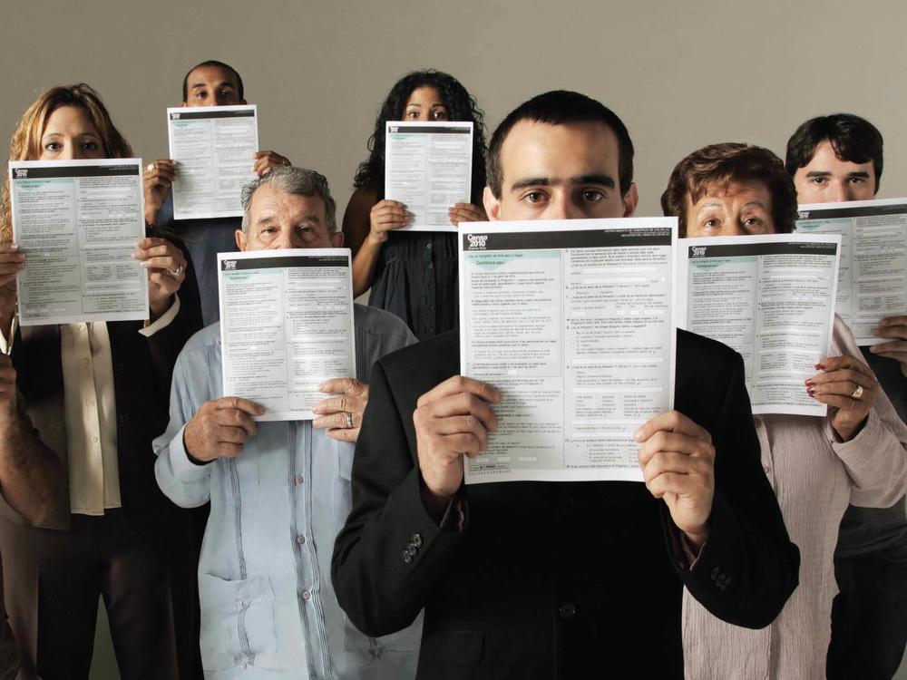 People conceal parts of their faces with forms for the 2010 count in Puerto Rico in a U.S. Census Bureau poster about how it keeps information confidential. Records for the once-a-decade tally cannot be released until 72 years after a count's Census Day.