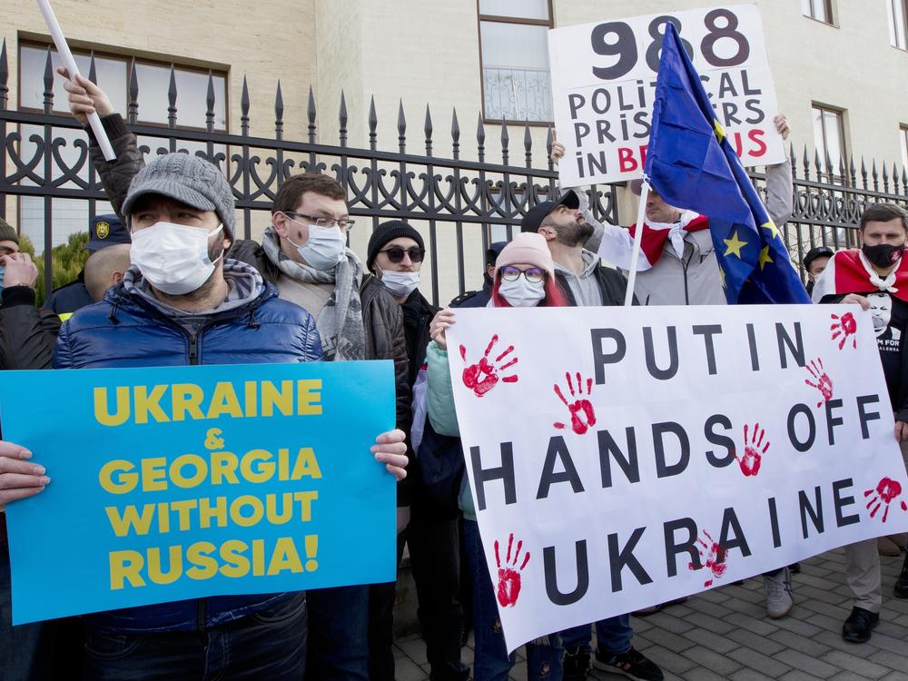 Georgian activists hold posters as they gather in support of Ukraine in front of the Ukrainian Embassy in Tbilisi, Georgia on Sunday, Jan. 23. The British government on Saturday accused Russia of seeking to replace Ukraine's government with a pro-Moscow administration.