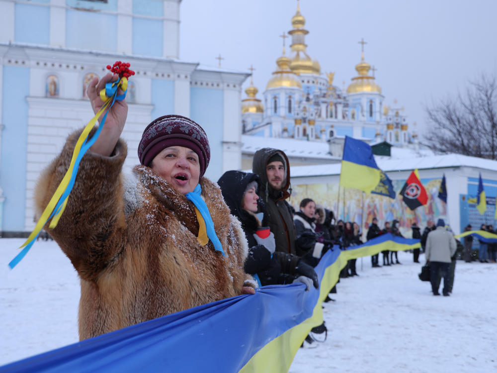 People rallying in patriotic support of Ukraine hold a 500 meter long ribbon in the colors of the Ukrainian flag outside St. Michael's Golden-Domed Monastery on Unity Day on Saturday in Kyiv, Ukraine.