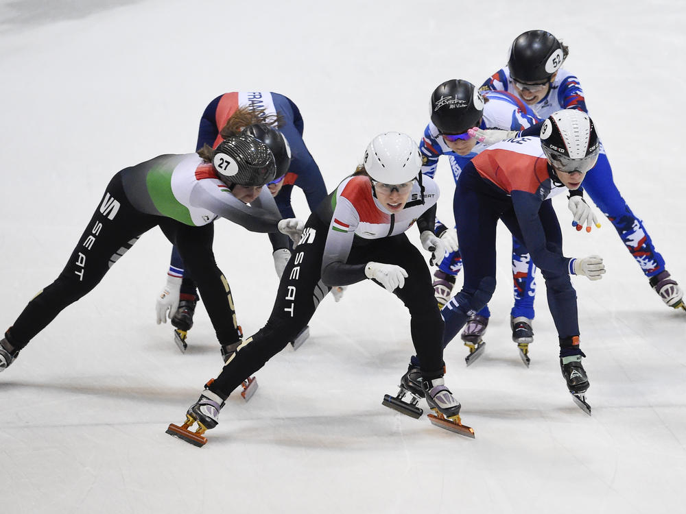 Team Hungary (left and first place), Team Russia (rear right and second place), and Team France, (front right, rear left, and third place), compete during the 2,000-meter mixed relay race of the World Cup short track speed skating championship in Dresden, eastern Germany, in 2020. Short track speedskating adds a new mixed relay event in Beijing.