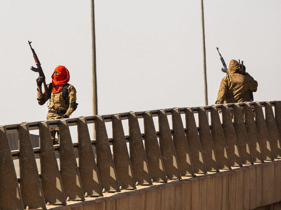 A mutinous soldier fires into the air at the Bobo interchange, near the Lamizana camp in Burkina Faso's capital Ouagadougou Sunday Jan. 23, 2022.