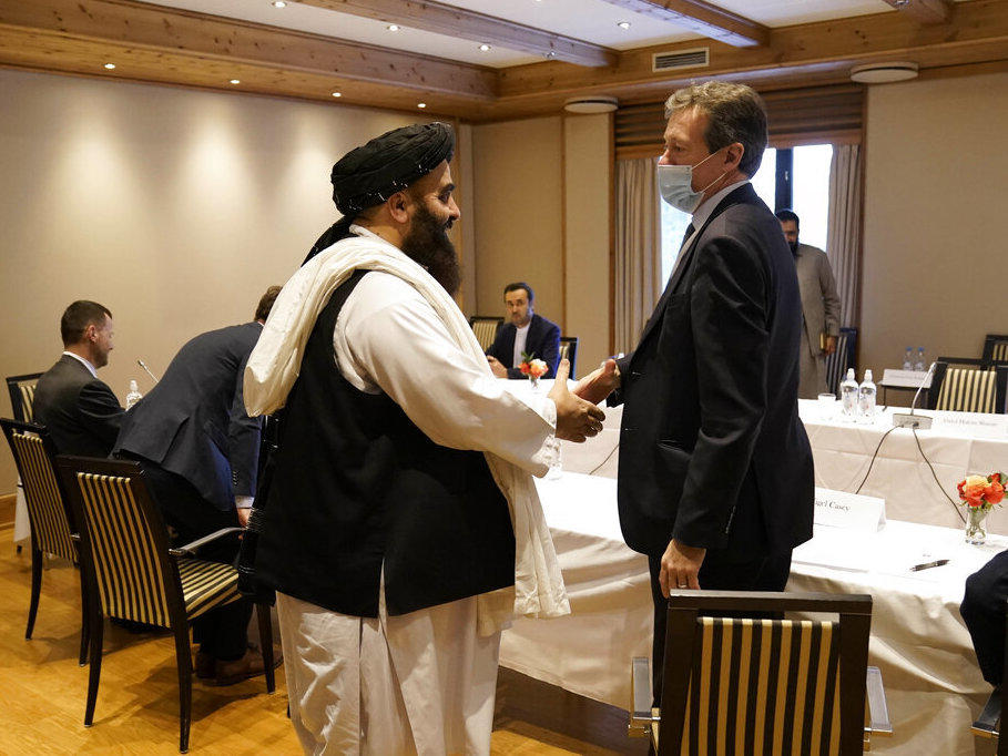 Special Representative for Afghanistan Nigel Casey, right, shakes hands with Taliban representative Amir Khan Muttaqi, center, ahead of a meeting in Oslo, Norway, Monday.