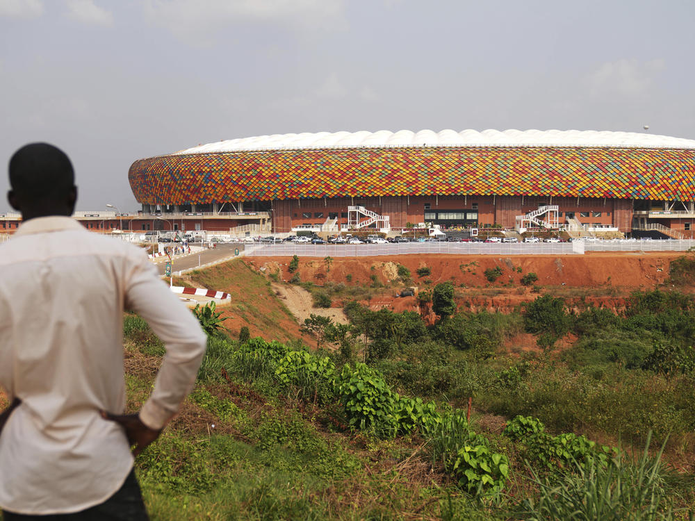 A man standing outside a newly build Olembe stadium in Yaoundé, Cameroon, on Jan. 8, 2022. A crush outside the stadium on Monday has left at least six people dead.