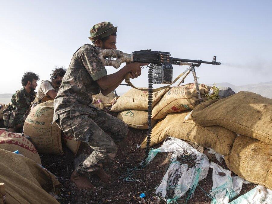 A Yemeni fighter backed by the Saudi-led coalition fires his weapon during clashes with Houthi rebels on the Kassara frontline near Marib, Yemen, Sunday, June 20, 2021.