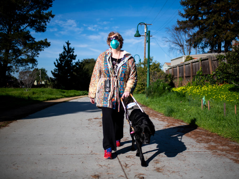 Sassy Outwater-Wright walks through her neighborhood with her guide dog, Ferdinand, in Berkeley on Jan. 20.