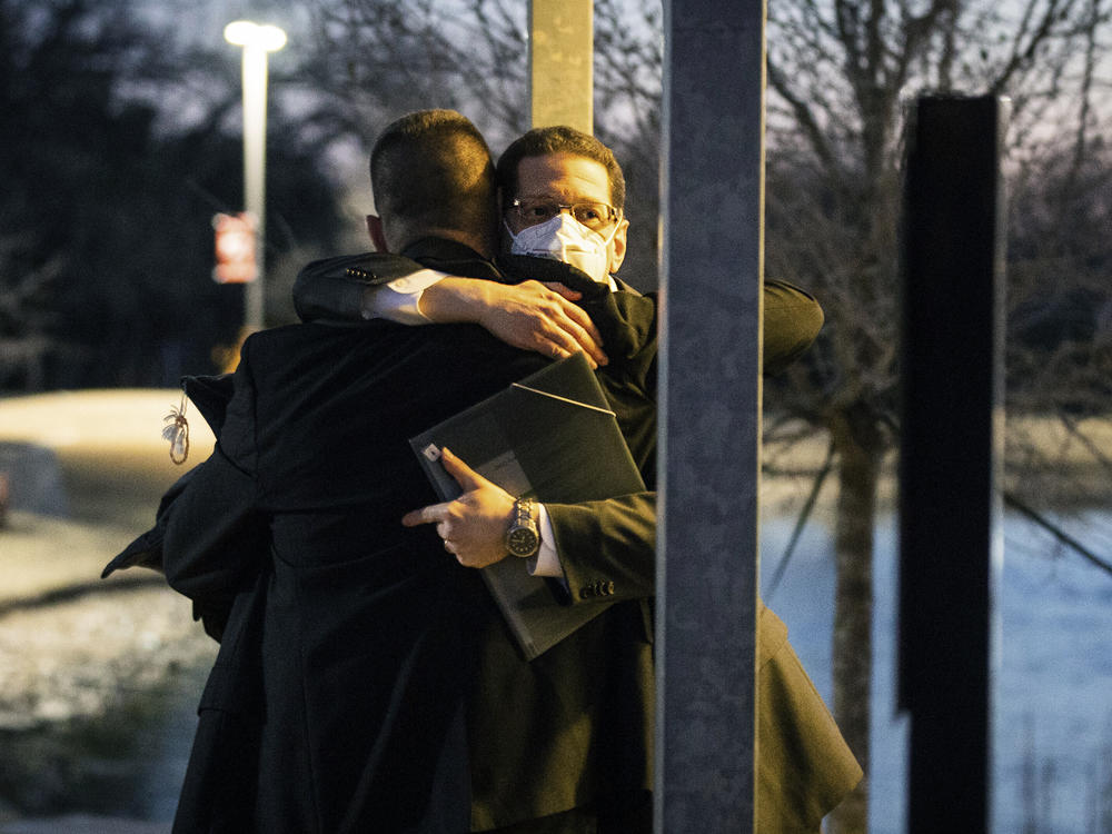 Congregation Beth Israel Rabbi Charlie Cytron-Walker, facing the camera, hugs a man after a healing service on Jan. 17, two days after he and three others were taken hostage at his Colleyville, Texas, synagogue.