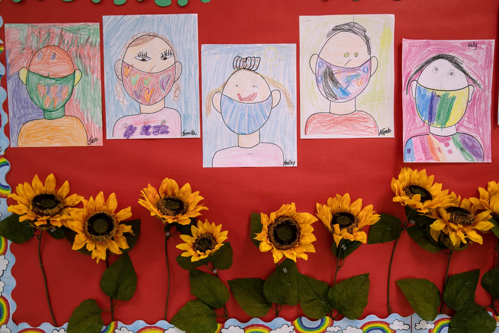 Drawings of children wearing masks adorn a hallway at Stark Elementary School on Sept. 16, 2020, in Stamford, Conn.