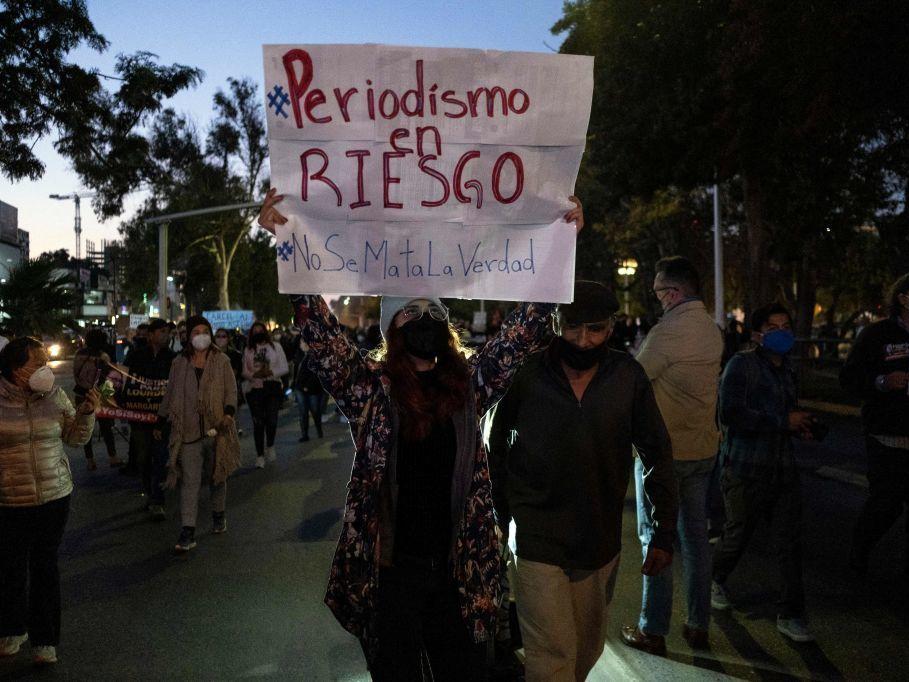 Journalists and supporters hold signs as they protest the murders of their colleagues Lourdes Maldonado and Margarito Martinez in Tijuana, Baja California, Mexico. The sign says, 