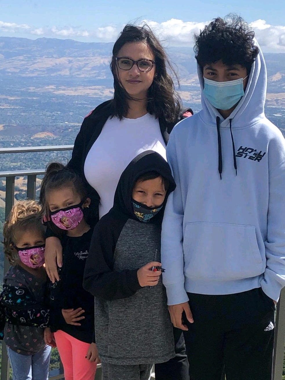 Maria Aguilar poses with her four kids (from left to right): Luna, Athena, Jio and Mauro while hiking California's Santa Cruz mountains in August 2021. Aguilar and Luna spent four hours in line waiting for a COVID-19 test in January.