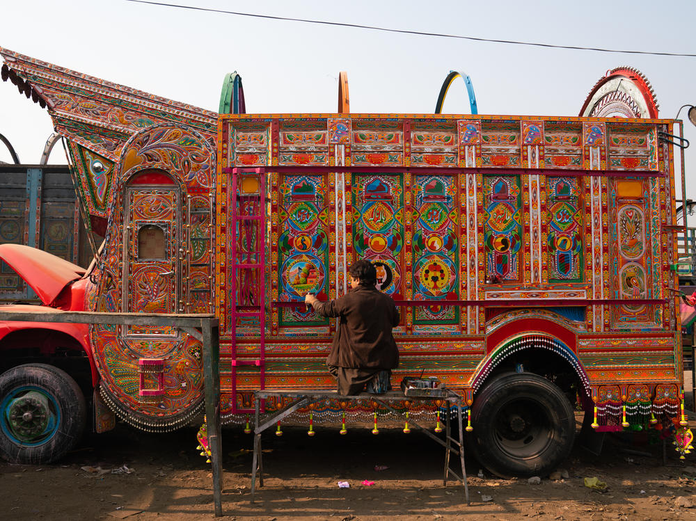 Painter Irfan Mohammad works on a truck at a sprawling workshop in Rawalpindi, Pakistan.
