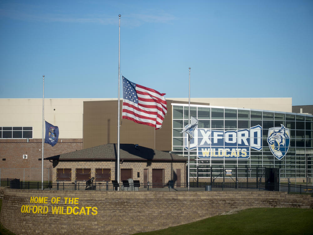 The American flag flies at half-staff on Dec. 2, 2021, outside of Oxford High School in Oxford, Mich.