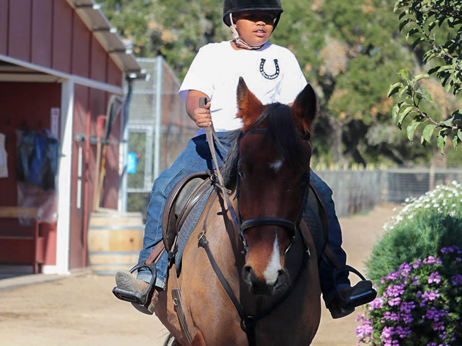 Jordan Humpreys seen riding his horse Winter at the Urban Saddles stables, in South Gate, Los Angeles.