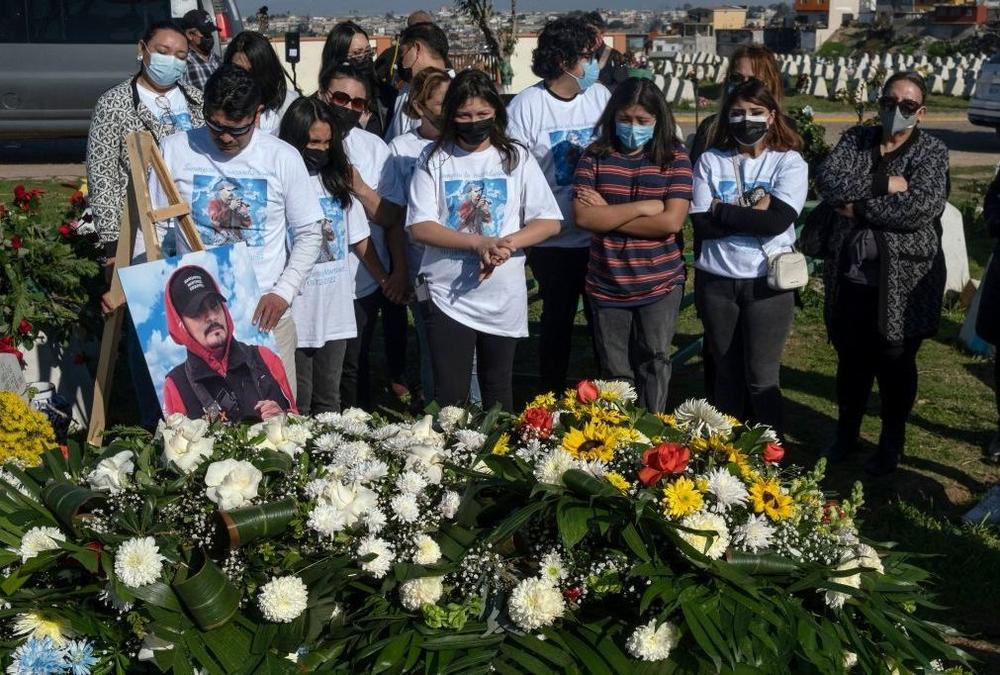 Relatives and friends of photojournalist Margarito Martinez mourn graveside in Tijuana, Baja California, Mexico.