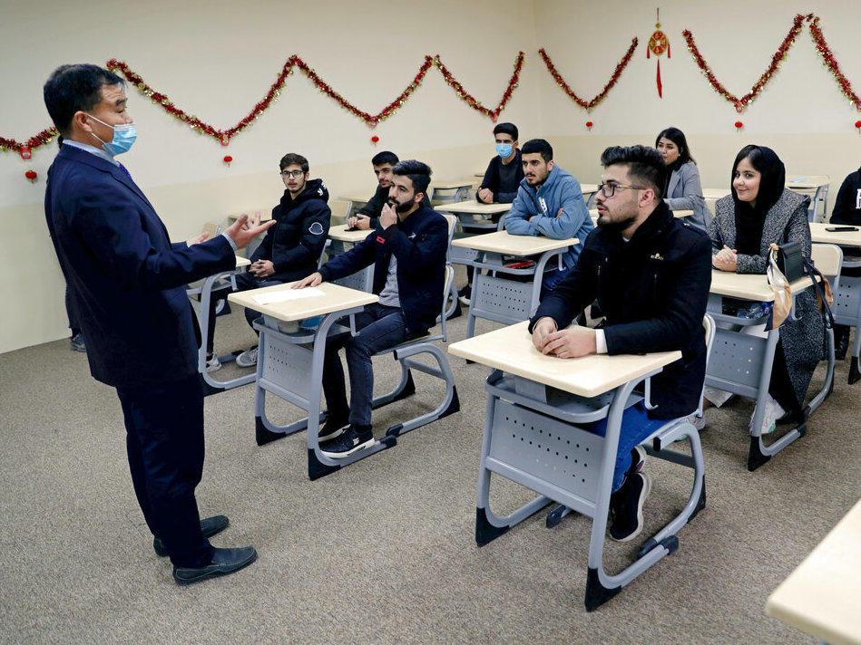 Chinese lecturer Zhiwei Hu speaks to students in the Chinese language department at Salahaddin University in Irbil, Iraq, Wednesday, Jan. 19, 2021.