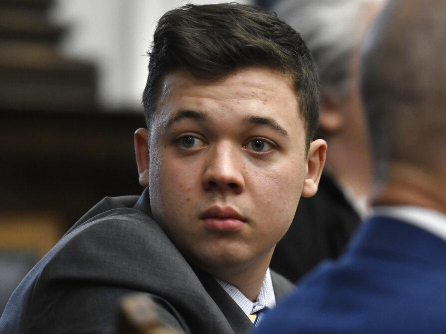 Kyle Rittenhouse looks back as attorneys discuss items in the motion for mistrial presented by his defense at the Kenosha County Courthouse in Kenosha, Wis., on Wednesday, Nov. 17, 2021.