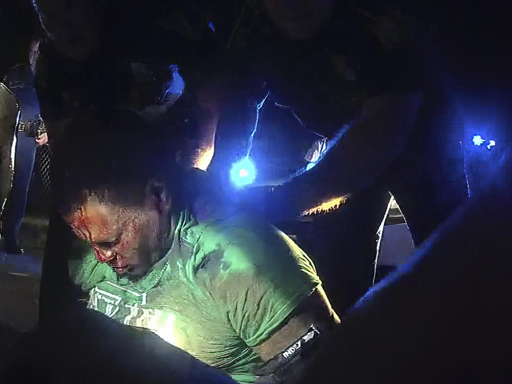 This image from video from Louisiana state trooper Dakota DeMoss' body-worn camera, shows troopers holding up Ronald Greene before paramedics arrived on May 10, 2019, outside of Monroe, La.