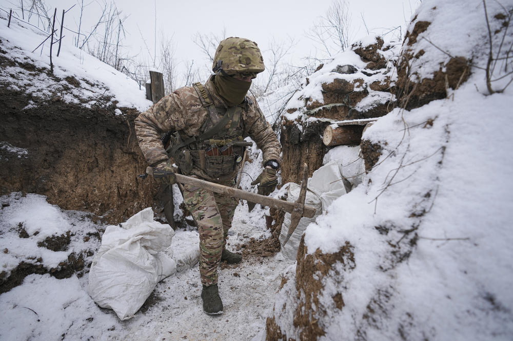 A Ukrainian serviceman works to fix a trench that was damaged by a mortar strike at a front line position in the Luhansk area of eastern Ukraine on Friday.