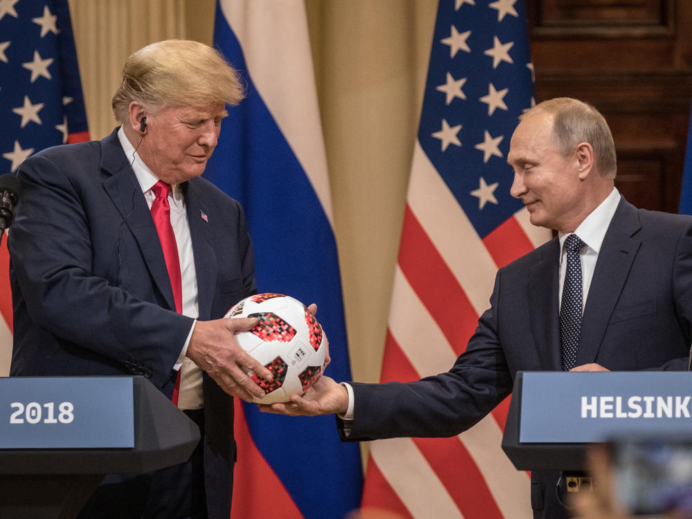 Russian President Vladimir Putin hands then-President Donald Trump a World Cup football during a joint press conference after their summit on July 16, 2018 in Helsinki, Finland.