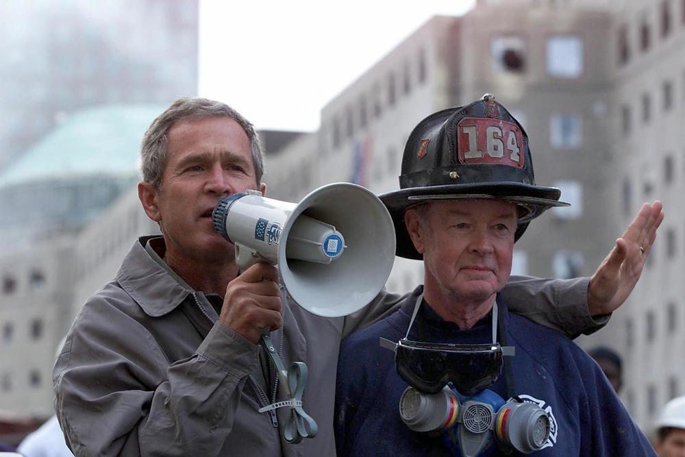 President George W. Bush, left, surveying the damage at the site of the World Trade Center on Sept. 14 2001 in New York City, just three days after the terrorist attack that brought down the towers.