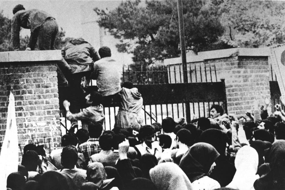 Iranian students climb over the wall of the U.S. embassy in Tehran on Nov. 4, 1979.