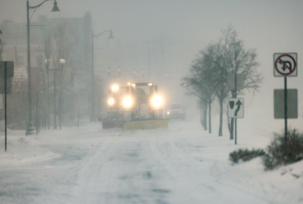 Snowplows clear snow from Broadway in Sullivan Square in Boston during the height of the storm on Saturday.