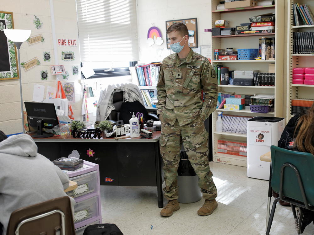 National Guard Specialist Austin Alt stands as he fills in as a substitute teacher due to staffing shortages caused by the coronavirus disease pandemic and other non-illness related absences at Pojoaque Valley Middle School in Pojoaque, N.M.