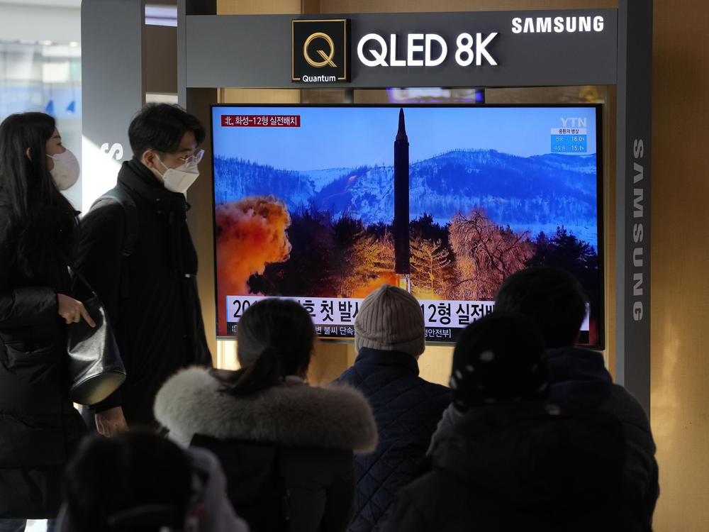 People watch a TV showing an image of North Korea's missile launch during a news program at the Seoul Railway Station in Seoul, South Korea on Monday, Jan 31.