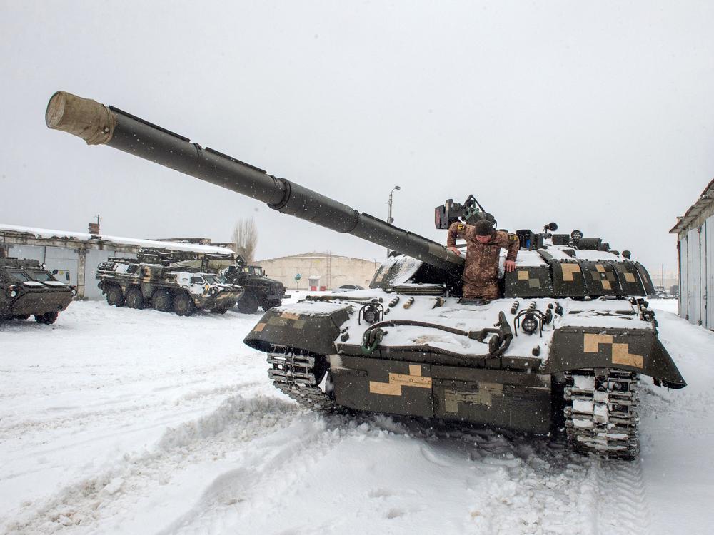 A Ukrainian military forces serviceman exits from a tank parked in a base near Klugino-Bashkirivka village, in the Kharkiv region on January 31, 2022.