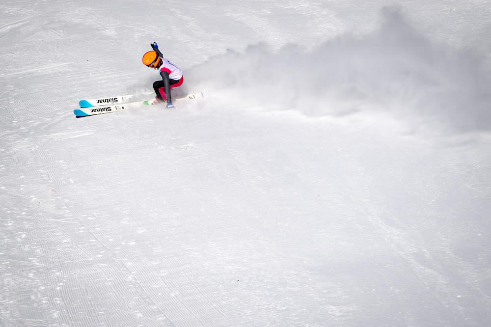 Isaac Larson, 13, stops after jumping the 40-meter hill at the Suicide Hill Ski Bowl in Ishpeming, Mich. on March 6, 2021. Larson hopes to one day compete in the winter Olympics.