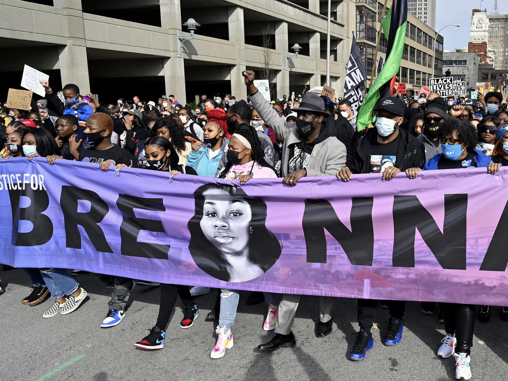 Tamika Palmer, center, the mother of Breonna Taylor, leads a march through the streets of downtown Louisville on the one year anniversary of Taylor's death on March 13, 2021, in Louisville, Ky.